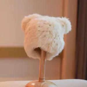Plush bear ear hat detail, warm winter fluffy cap closeup, soft cozy cute furry headwear.