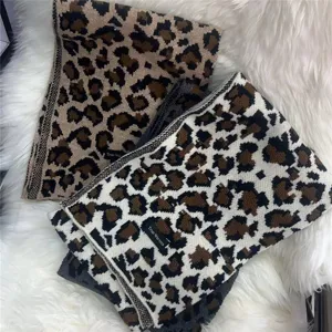 Leopard knit winter scarf detail shot, cozy thick wool blend fashion neck warmer for women.