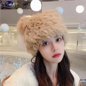 Close-up detail shot of the cute fluffy bear ear plush winter hat, warm fashion style.