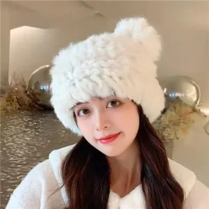 Close-up detail of the fluffy white plush winter ear-protection hat with cute bear ears.