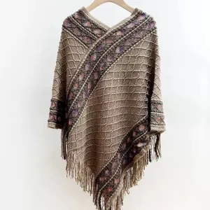 Knit poncho shawl detail, brown fringe cape, cozy winter wear, vintage style outerwear close up