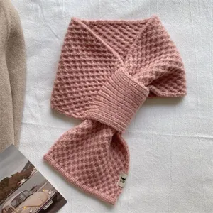 Pink knitted cross scarf detail, cozy winter neck warmer and stylish thermal winter accessory.