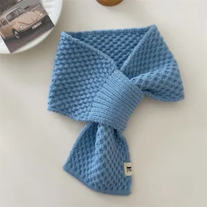 Detail view of the cozy blue knitted winter neck scarf, soft cross-design warm student neckerchief.