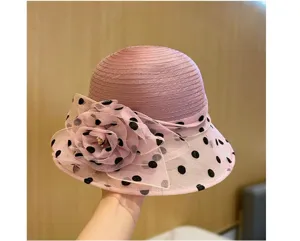 Elegante cappello da donna in organza rosa a pois con decorazione floreale estiva.