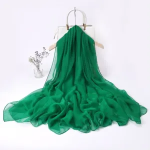 Green chiffon long scarf detail view, elegant draping, perfect spring fashion accessory.