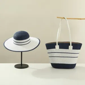 Summer straw hat and woven tote bag set, fashionable navy blue and white striped design.