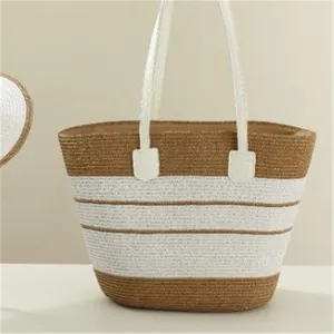 Detailed view of a chic straw woven handbag featuring stylish white and brown striped design.