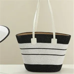 Close-up detail of the stylish black and white striped straw tote bag, exquisite woven texture.