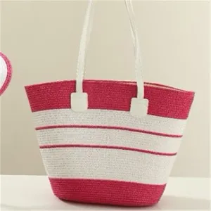 Detailed view of the pink and white striped straw woven texture and clean white double handles.