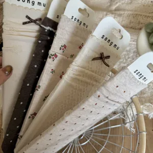 Korean floral stacking socks detail view, cozy oatmeal cotton mid tube socks display.