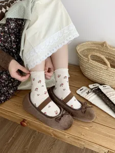 Retro floral mid-tube socks detail view, featuring cute ruffled edge and cozy cheese color fabric.