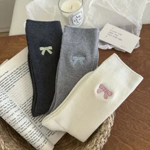 Detailed view of women cotton mid-calf socks featuring delicate embroidered aesthetic bows.
