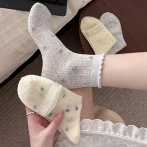 Close-up detail of Korean style floral lace ruffle short socks with heart jacquard pattern.