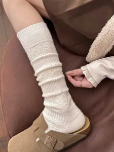 Knit calf socks detail shot, cozy winter wool ribbed leg warmers with diamond pattern.