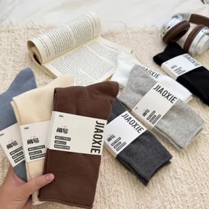 Detalle de calcetines de algodón para hombre en color liso con tela suave, transpirable y empaque.