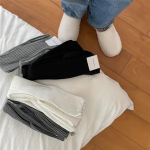 Detailed view of women's chunky ribbed over-the-knee high socks in various solid colors.