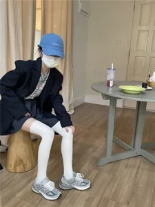 White ribbed over-the-knee socks detail shot, casual daily wear style, comfortable fit.