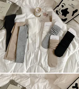 Detailed view of women knitted slouch socks, autumn winter solid color high long tube socks.
