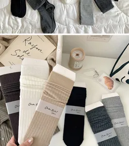 Detailed view of women's casual solid color stack socks in various colors, soft fabric.