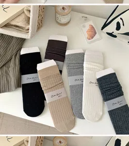 Comfortable solid color knit crew socks for women, stylish stackable casual long socks.