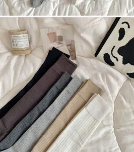 Solid color long tube socks for women, comfortable knit high knee socks, autumn winter wear detail.