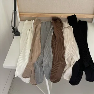 Detailed view of ribbed over-the-knee long socks in multiple solid colors, cozy knit hosiery.