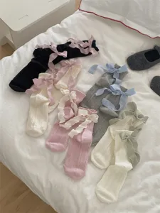 Details of Korean style ribbon bow mid-tube socks with cable knit texture, soft fabric.
