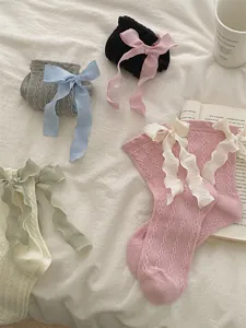 Korean style sweet Lolita mid-tube socks featuring long ribbon bows and cute knit texture.