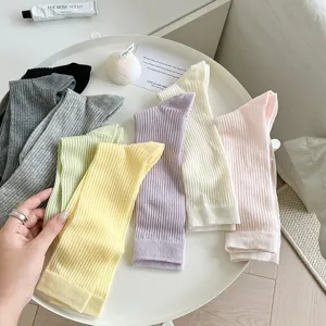 Detailed view of colorful ribbed mid-tube socks, soft combed cotton everyday wear.