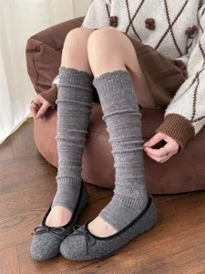 Grey knitted wool stirrup leg warmers detail view, cozy winter warm long socks for women.