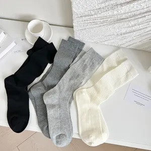 Detailed view of women ribbed mid tube socks in classic colors, showing fine knit texture.