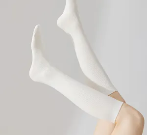 White ribbed knee high socks for women, classic cotton over the calf hosiery for daily wear.