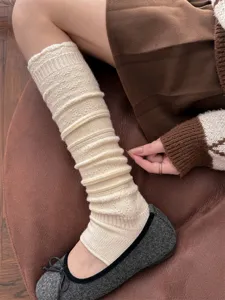 Knitted stirrup leg warmer detail, cream white hollow out design, cozy winter accessory.