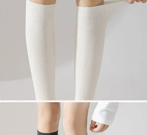 Detailed view of white ribbed knee high socks showcasing fine elasticity and cozy texture