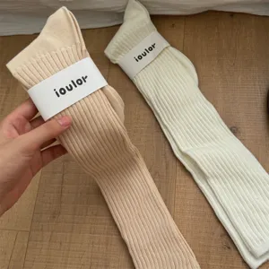 Close-up detail of ribbed knit long socks with brand label, soft warm winter casual hosiery.