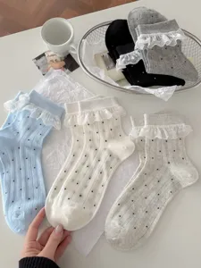 Detailed view of women sweet lace ruffle mid-tube socks with cute polka dots for spring.
