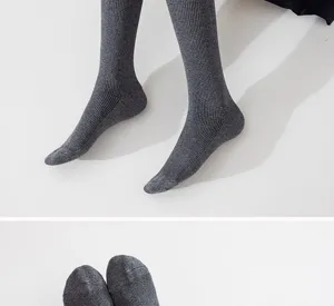 Detail view of grey ribbed long socks, showcasing soft knit texture and comfortable fit design.