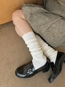 Detailed view of cozy knit slouch socks, soft white winter tube socks for casual daily wear.