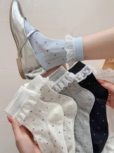 Sweet women mid-tube socks featuring cute polka dots and delicate lace ruffle trim for spring and summer.