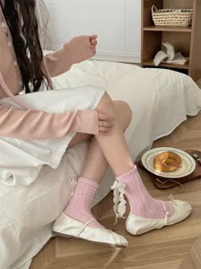 Sweet pink lolita mid-calf socks for women, featuring elegant white lace bow ribbons and soft knit.