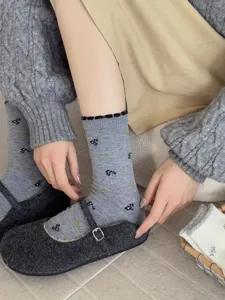 Detailed view of cozy grey mid-tube socks with delicate floral pattern, soft winter knit wear.