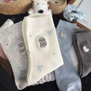 Charming cute puppy embroidered cotton mid-tube socks detail view, sweet bow pattern, cozy flatlay.