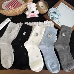 Cute puppy embroidered women mid tube socks detailed flat lay view with cartoon animal patterns.