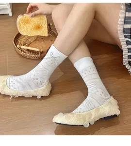 Detailed view of white sweet mesh mid-tube socks with cute bowknot design, soft daily wear.