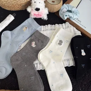 Detail shot of cute puppy embroidered mid-tube cotton socks with bow print in multi colors.