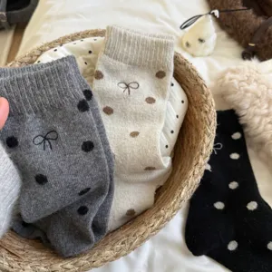 Cozy women's thick warm wool socks featuring cute polka dots and bow embroidery details.