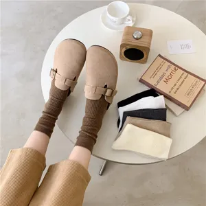 Detailed view of women's autumn winter ribbed mid tube socks in stylish Maillard brown tone.