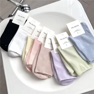 Detailed view of colorful cotton mid-tube women socks neatly arranged with paper tags display.
