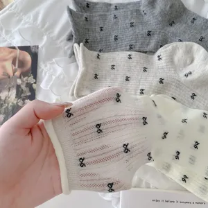 Sheer summer women socks featuring delicate black bow prints and breathable thin fabric.