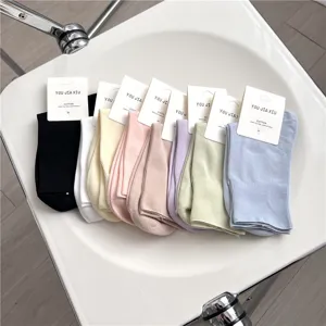 Detail view of colorful cotton crew socks, soft pastel tones, comfortable loose-top design.